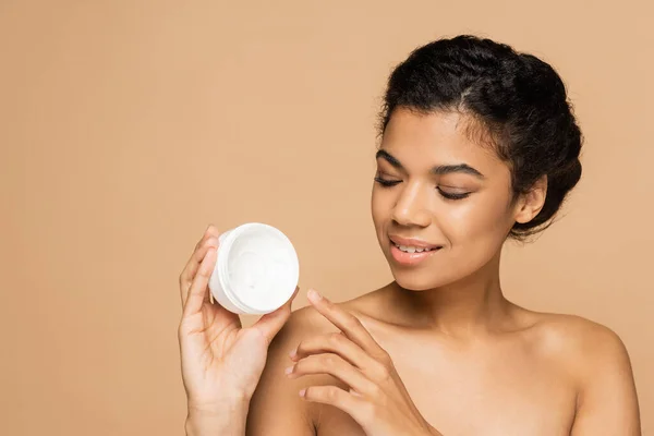 Smiling African American Woman Bare Shoulders Looking Container Face Cream — Stock Photo, Image