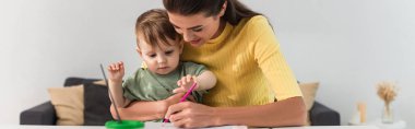 Mother and kid drawing at home, banner  clipart