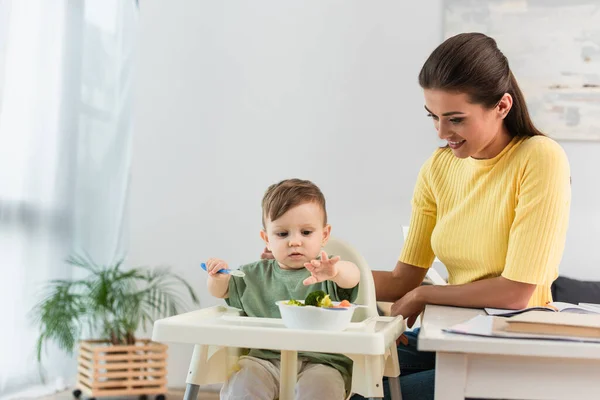 Happy Woman Looking Son Sitting Bowl Vegetables High Chair — Stock Photo, Image