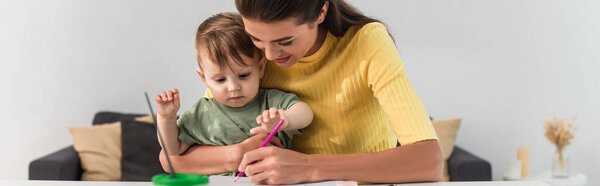 Mother and kid drawing at home, banner 
