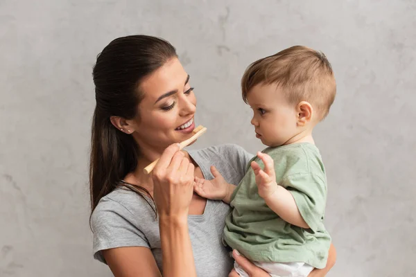 Sonriente Madre Sosteniendo Cepillo Dientes Niño Casa — Foto de Stock