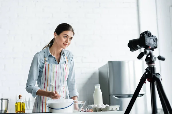 Young Woman Apron Looking Digital Camera Flour Milk Chicken Eggs — Stock Photo, Image