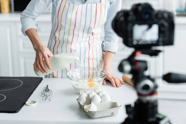 Cropped View Woman Apron Adding Milk Bowl Flour Eggs Blurred — Stock Photo, Image