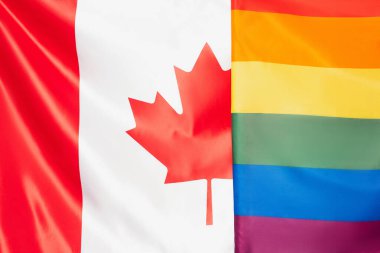 close up of canadian and lgbt flags, equality rights concept