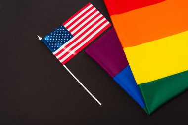 high angle view of american and lgbt flags isolated on black, equality rights concept 