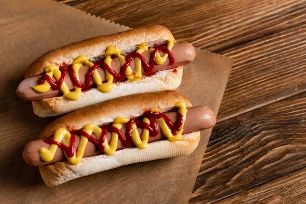 Top View Delicious Hot Dogs Craft Parchment Wooden Surface — Stock Photo, Image