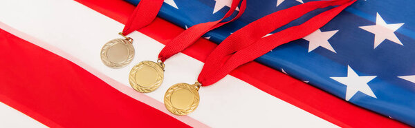 high angle view of golden medals on american flag, banner