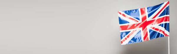 British flag of united kingdom with red cross isolated on grey, banner
