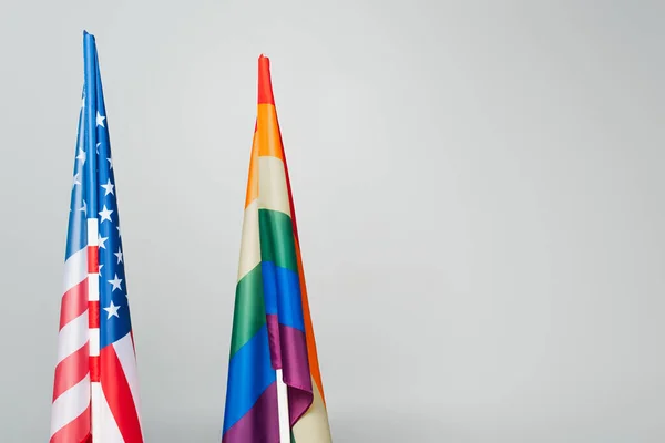american and colorful lgbt flags isolated on grey, equality rights concept