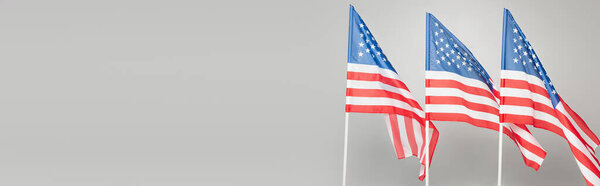 red and blue flags of usa with stars and stripes isolated on grey, banner