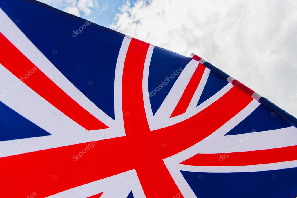 close up view of national flag of united kingdom with red cross against sky 