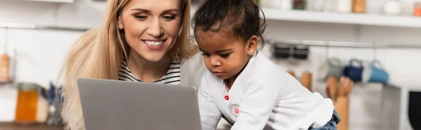 Feliz Freelancer Mirando Portátil Cerca Adoptado Afroamericano Hija Cocina Bandera — Foto de Stock