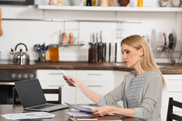 Freelance Blonde Regardant Les Graphiques Tout Travaillant Maison Près Gadgets — Photo