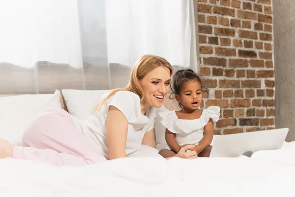 Cheerful Mother Adopted African American Girl Watching Movie Laptop Bedroom — Stock Photo, Image