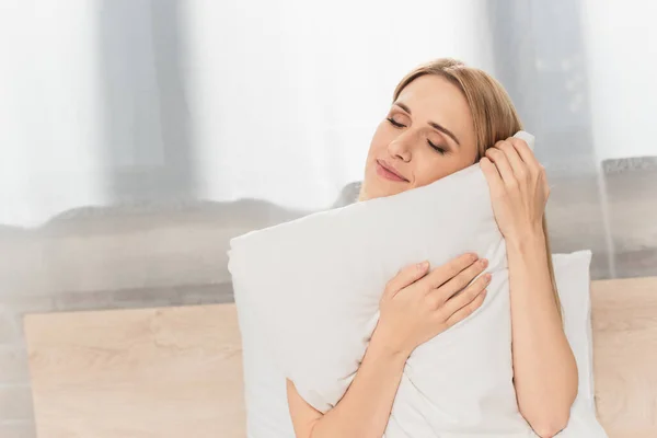 Happy Blonde Woman Closed Eyes Holding Pillow Bedroom — Stock Photo, Image