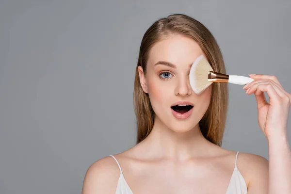 Amazed Young Woman Holding Cosmetic Brush Isolated Grey — Stock Photo, Image