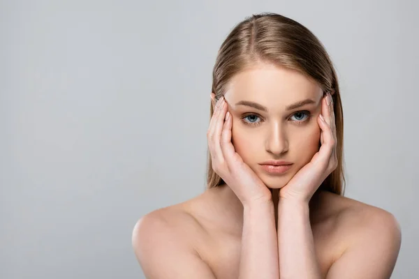 Junge Frau Mit Blauen Augen Berühren Gesicht Isoliert Auf Grau — Stockfoto