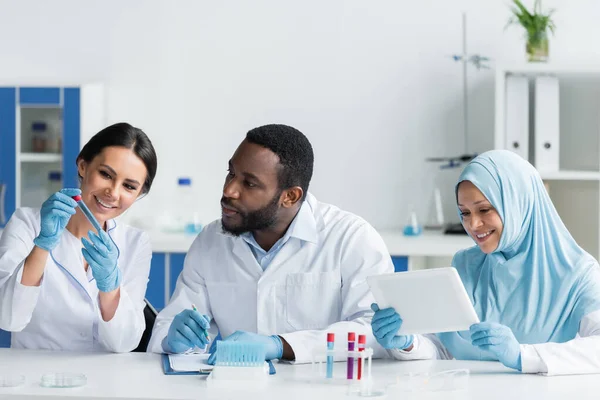 Smiling Scientist Holding Test Tube Interracial Colleagues Clipboard Digital Tablet — Stock fotografie