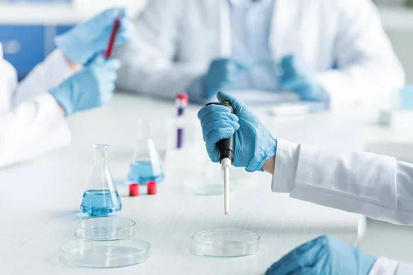 Cropped View Scientist Holding Electronic Pipette Petri Dish Flasks — Stock Fotó