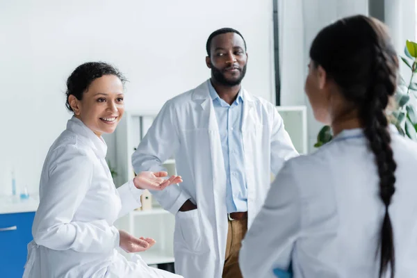 African American Doctor Talking Colleague Blurred Foreground Clinic — Stock Photo, Image