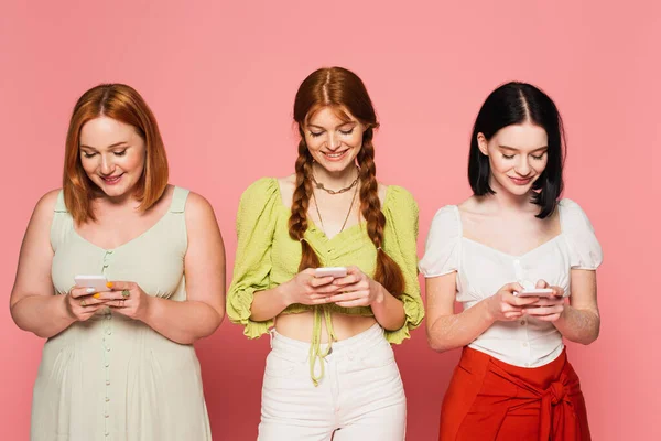 Corpo Sorridente Mulheres Positivas Usando Smartphones Isolados Rosa — Fotografia de Stock