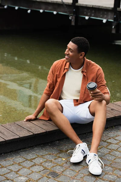 Happy African American Man Takeaway Drink Sitting Border Water City — Stock Photo, Image