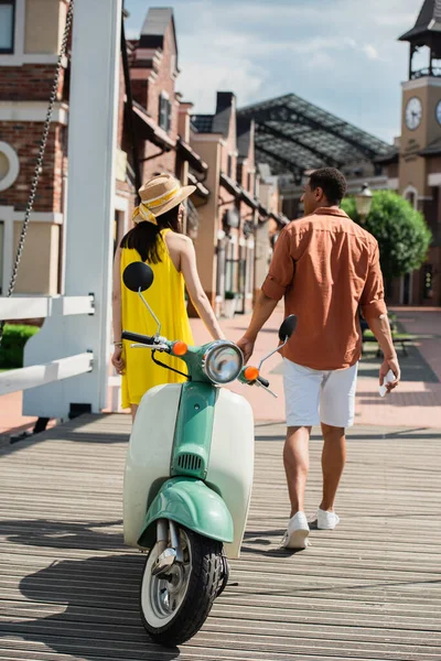 Back View Interracial Couple Holding Hands While Walking Bridge Scooter — Stock Photo, Image