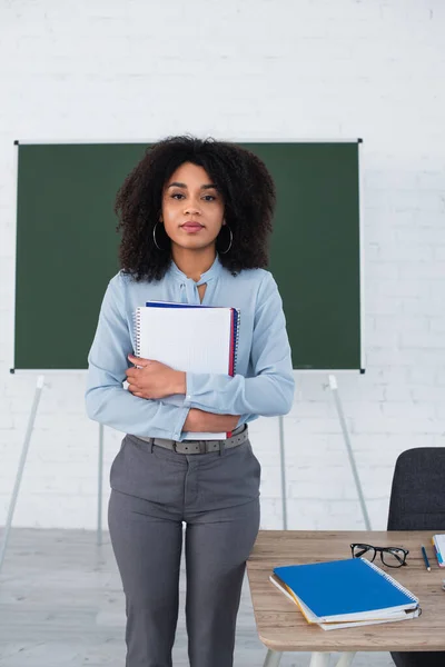 Professor Afro Americano Segurando Cadernos Olhando Para Câmera Sala Aula — Fotografia de Stock