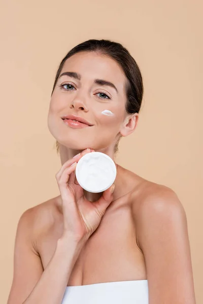Charming Woman Stroke Cream Face Holding Cosmetic Container Isolated Beige — Fotografia de Stock