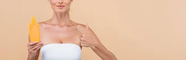 Cropped View Woman Orange Bottle Sunscreen Showing Thumb Isolated Beige — Stock Photo, Image