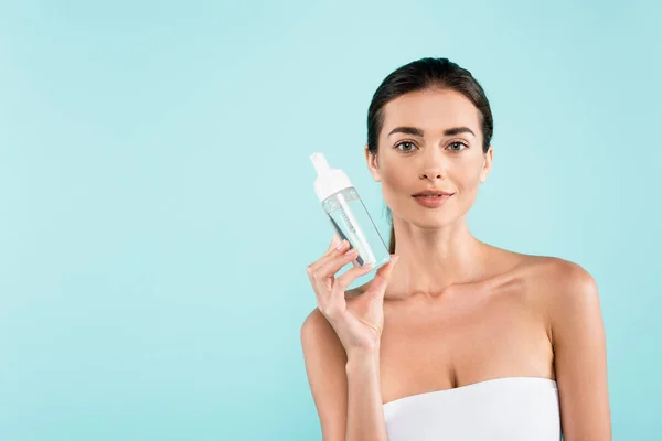 Brunette Woman White Strapless Top Showing Face Tonic Isolated Blue — Stok Foto