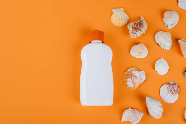 Top View Seashells White Bottle Sunblock Orange Surface — Fotografia de Stock