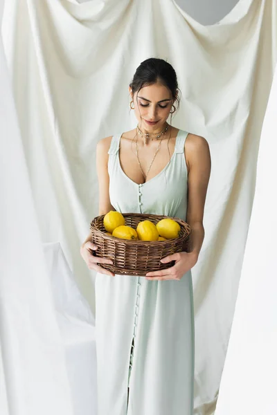 Donna Sorridente Abito Cercando Limoni Maturi Vimini Cestino Bianco — Foto Stock