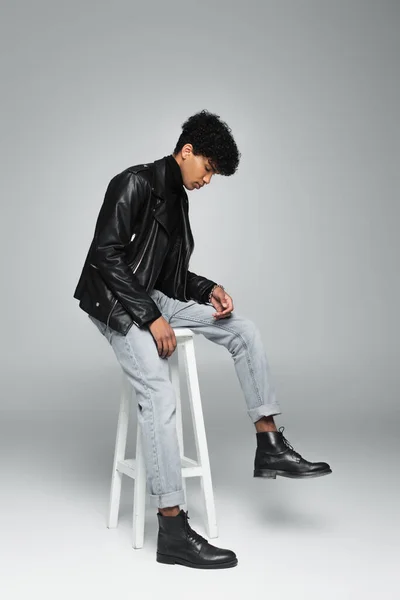 Young African American Man Jeans Black Leather Boots Jacket Sitting — Stok fotoğraf