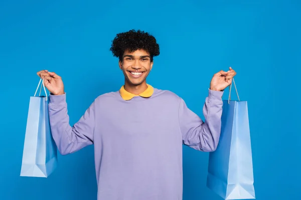 Happy African American Man Looking Camera While Holding Shopping Bags — Stok fotoğraf