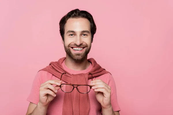 Young Man Holding Eyeglasses Smiling Camera Isolated Pink — Stock Photo, Image