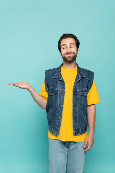 Homme Souriant Shirt Gilet Denim Pointant Main Isolé Sur Bleu — Photo