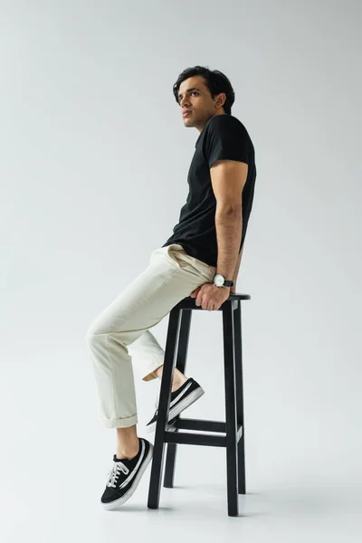 Full Length Young Man Black Shirt Sitting Chair Grey — Stock Photo, Image