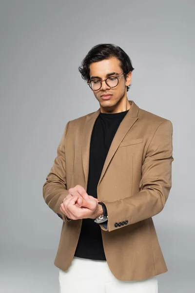 Young Man Stylish Eyeglasses Adjusting Wristwatch Isolated Grey — Stock Photo, Image