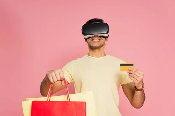 Hombre Alegre Auriculares Celebración Bolsas Compras Tarjeta Crédito Aislado Rosa — Foto de Stock