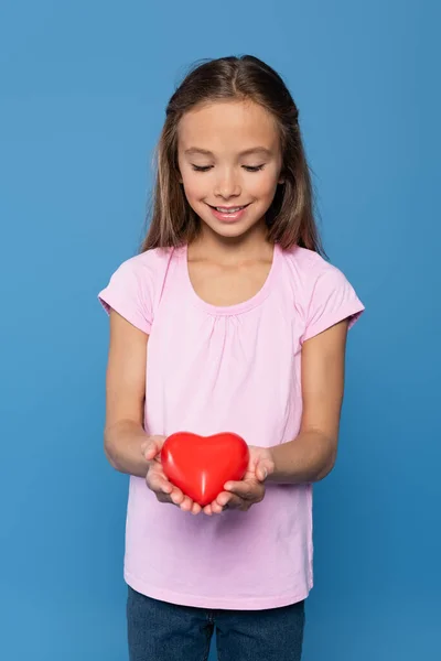 Smiling Girl Pink Shirt Holding Red Heart Isolated Blue —  Fotos de Stock