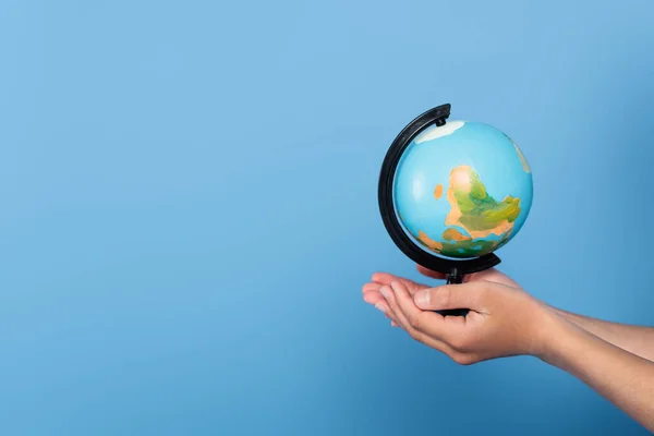 Vista Cortada Estudante Segurando Globo Mãos Isoladas Azul — Fotografia de Stock