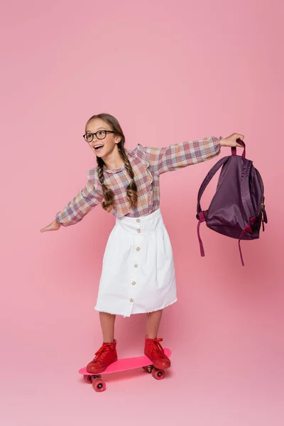 Schoolgirl Backpack Riding Penny Board Pink Background — Photo