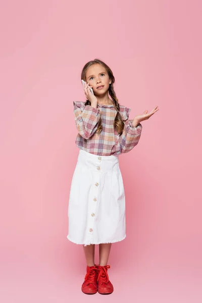 Full Length View Stylish Child Gesturing While Talking Cellphone Pink — Stock Photo, Image