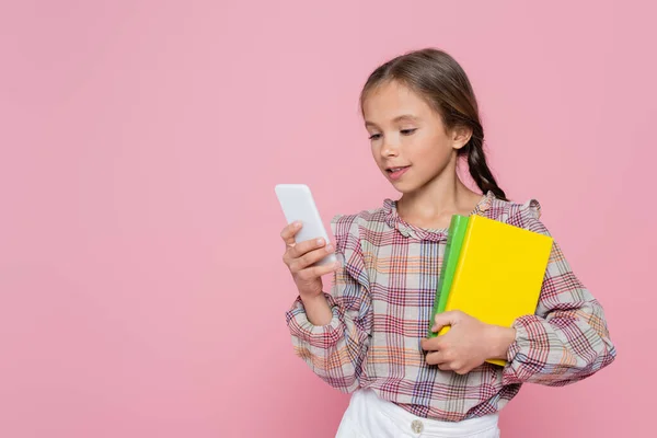 Preteen Girl Books Using Mobile Phone Isolated Pink — Stock Photo, Image