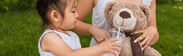 Asiático Niño Niña Holding Plástico Taza Con Milkshake Cerca Teddy —  Fotos de Stock