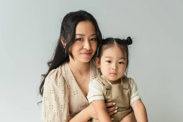 Cheerful Asian Woman Hugging Toddler Daughter Isolated Gray — Stock Photo, Image