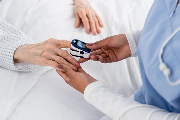 Cropped View African American Nurse Fastening Oximeter Finger Senior Patient — Stock Photo, Image