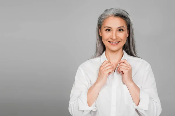 Pleased Asian Woman Adjusting Collar White Shirt While Looking Camera — Stock Photo, Image