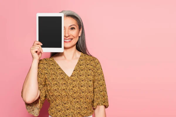 Smiling Asian Woman Obscuring Face Digital Tablet Isolated Pink — Stock Photo, Image